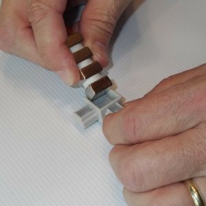 Neodymium Magnets being inserted into connectors for use with Magnetic Mounting Filters